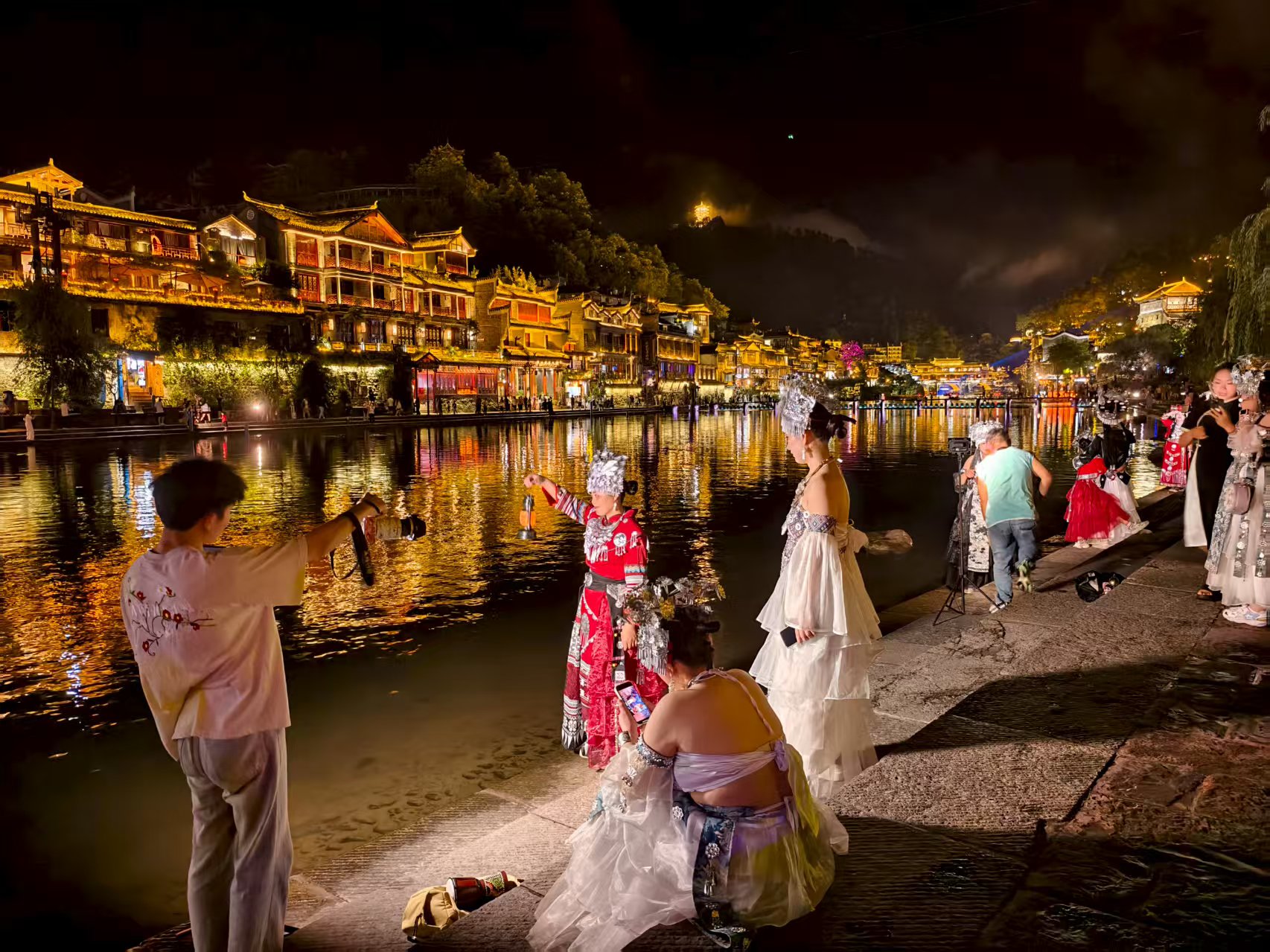 在湖南湘西土家族苗族自治州鳳凰古城，游客身著苗族特色服裝打卡拍照。人民網(wǎng)記者 喬業(yè)瓊攝