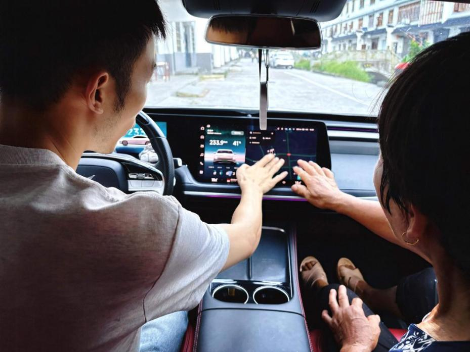 阿豪向村里的老人演示新能源汽車的智能體驗(yàn)。受訪者供圖