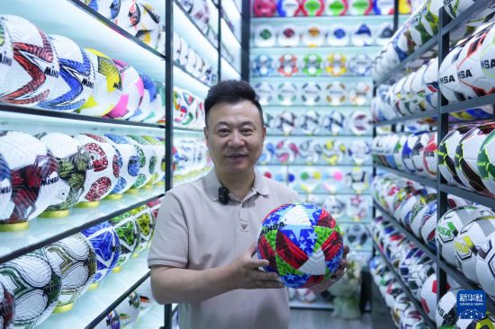 5月15日，在義烏國(guó)際商貿(mào)城專門(mén)銷售球類的商戶陳紹美展示今年自主設(shè)計(jì)生產(chǎn)的熱銷足球。
